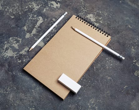 Blank kraft notebook, pencils and eraser. Branding template. Mock-up for design presentations and portfolios.