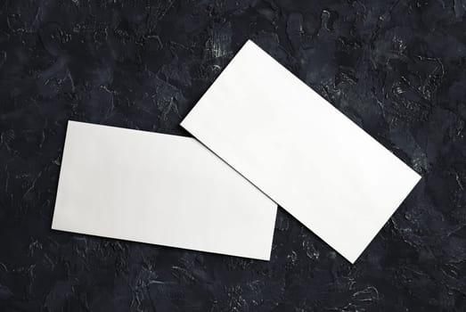 Photo of blank white paper envelopes. Template for branding identity. Top view.