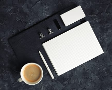Blank branding stationery set on black plaster background. Corporate stationery template. Top view. Flat lay.
