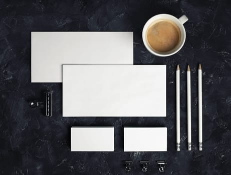 Blank stationery set on black plaster background. Corporate identity template. Responsive design mockup. Top view. Flat lay.