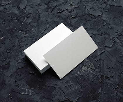 Blank business cards template on black plaster background. Mockup for branding identity for designers.