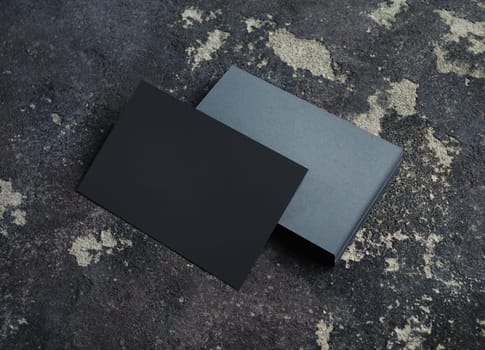 Blank grey paper business cards on concrete background. Copy space for text.