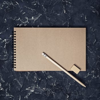 Blank vintage sketchbook, pencil and eraser. Blank branding template. Mock-up for design presentations and portfolios. Top view.