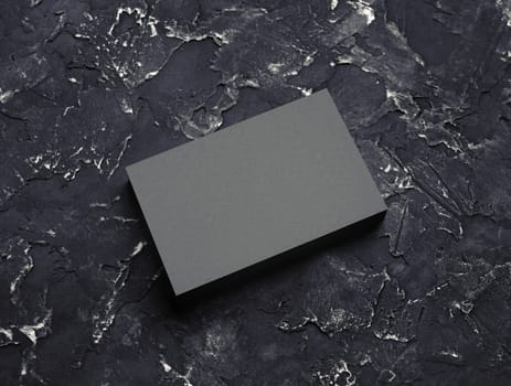 Blank grey business card mockup on black plaster background. Responsive design template.