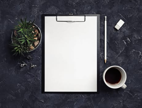 Blank stationery set on black plaster background. Top view.