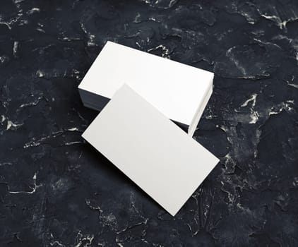 Blank business cards on black plaster background. Mockup for branding identity for designers.