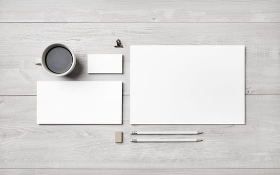 Blank corporate stationery set on light wooden background. Template for branding identity. Flat lay.