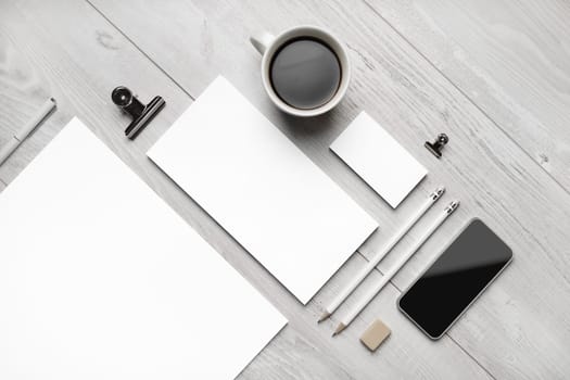 Blank business stationery set. Corporate identity template on light wooden background. Flat lay.