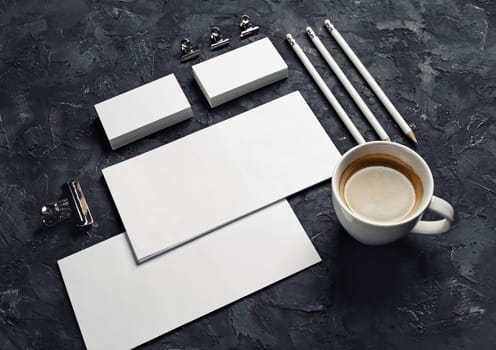 Blank stationery and corporate identity template on black plaster background. Responsive design mockup.