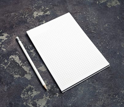 Branding stationery mockup. Copybook and pencil on concrete background. Blank objects for placing your design.