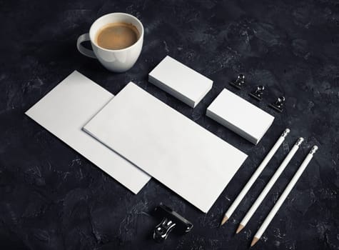 Photo of blank stationery set on black plaster background. Blank stationery template for branding identity.