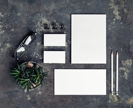 Blank corporate stationery set on concrete background. Template for branding ID. Top view. Flat lay.