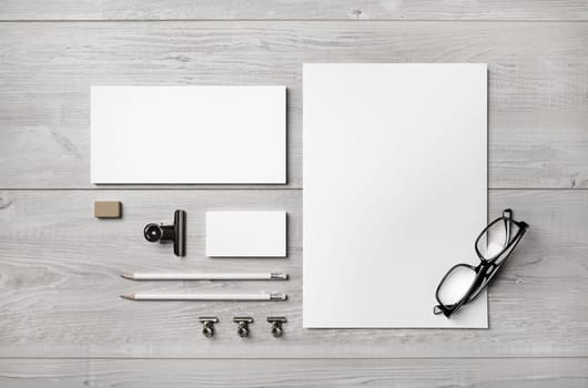 Blank branding stationery set. Business brand template on light wooden background. Top view.