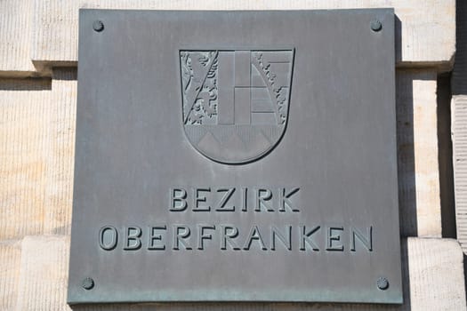 Bronze shield from the district of Upper Franconia on a historic building in Bayreuth. The city of Bayreuth is located in Bavaria,Germany.