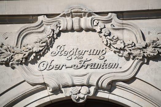 Sandstone sign from the government of Upper Franconia on a historic building in Bayreuth. The city of Bayreuth is located in Bavaria,Germany.