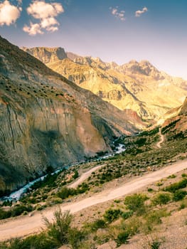 Scenic mountain road to Iskanderkul - an alpine lake in the mountains of Tajikistan