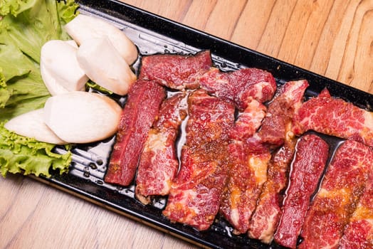 Raw pork on plate, Korean traditional style fresh pork beef belly BBQ, Japanese meat hot pot or Shabu in the restaurant, barbecue food