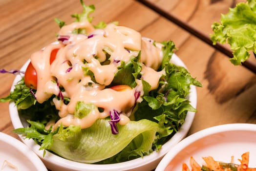 Spicy Kimchi. Korean pickle or Pickled radish vegetables and seasoning on bowl on wood table background, Japanese food