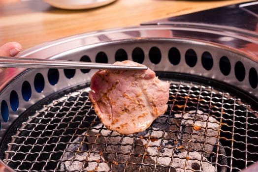 Korean beef barbecue on hot coals. Grilling meat pork Korean BBQ traditional style on stove serve in restaurant, Japanese food