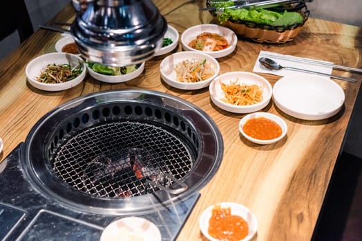 Spicy Kimchi group. Korean pickle or Pickled radish vegetables set and seasoning on bowl on stove serve wood table background, Japanese food