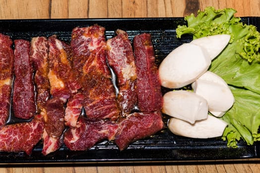 Premium frozen raw pork on plate, Korean traditional style fresh pork beef belly BBQ, Japanese meat hot pot or Shabu in the restaurant, barbecue food
