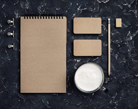 Photo of blank kraft stationery set on black plaster background. Business brand template. Branding mock up. Top view.