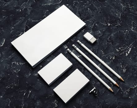Brand identity mockup. Blank corporate stationery set on black plaster background.