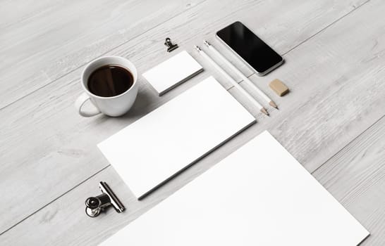 Photo of blank branding stationery template on light wooden background. Responsive design mockup.