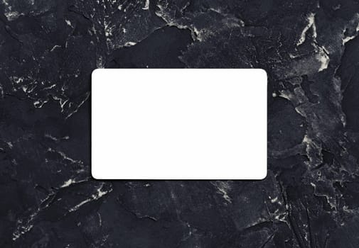 Blank white business card on black plaster background. Mockup for branding identity. Top view.
