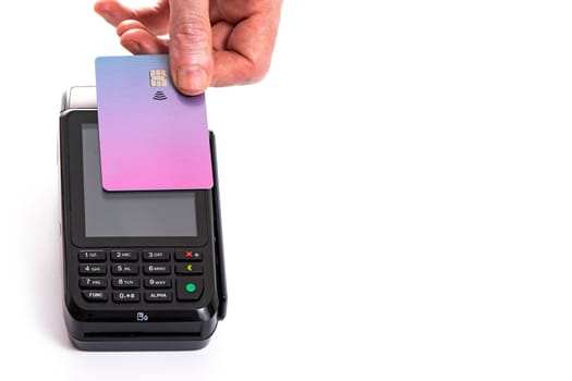 Attached plastic card to the payment terminal with a man's hand on a white isolated background, copy space. High quality photo