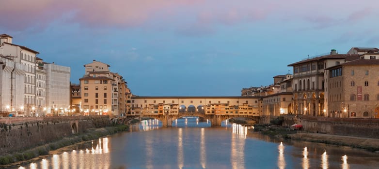 Florence, Italy - circa July 2021. Sunset light on Ponte Vecchio - Old Bridge.