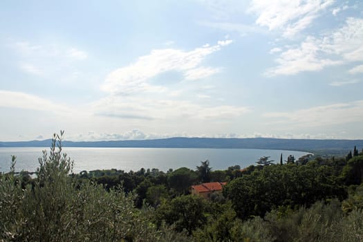 A panoramic view of Lake Trasimeno with trees in the south of Italy