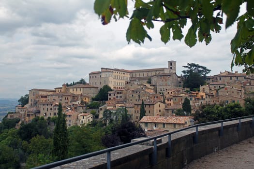 The historical city of Gubbio laying on a green hill in Umbria in Italy