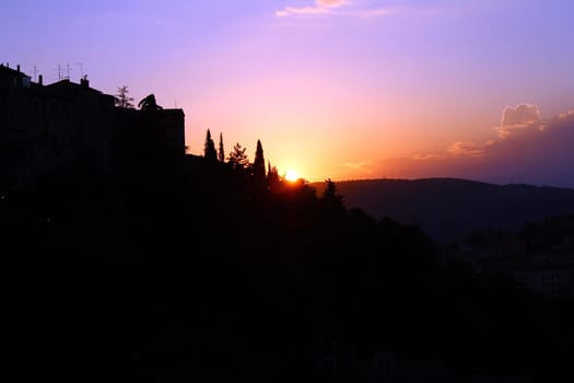 A purple sunset on the hills of Umbria from Perugia in Italy