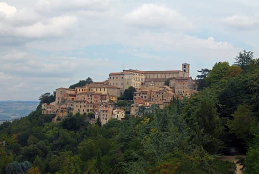The historical city of Gubbio laying on a green hill in Umbria in Italy