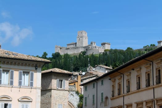 The Rocca Maggiore of Assisi on the top of the hill overlooking the houses below in Umbria in Italy