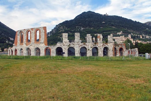 The historic arena in the center of Gubbio with the grass around in Umbria in Italy