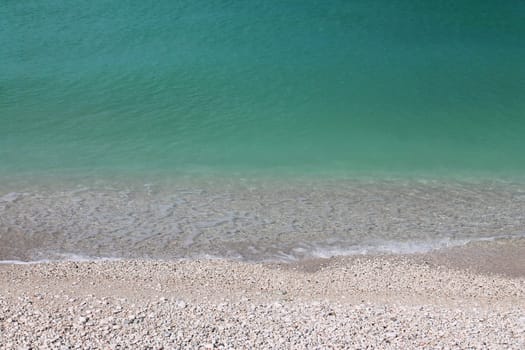The turquoise water on the white stones of the Conero beaches in Italy