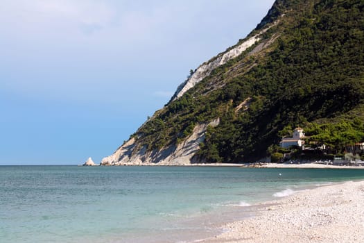 Dramatic sky above the turquoise Adriatic Sea and the white rocks in Portonovo on Conero in Italy