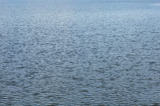 Water surface with small waves, abstract nature background.