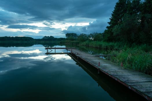 A long wooden pier and a cloudy dark sky, Stankow, Lubelskie, Poland