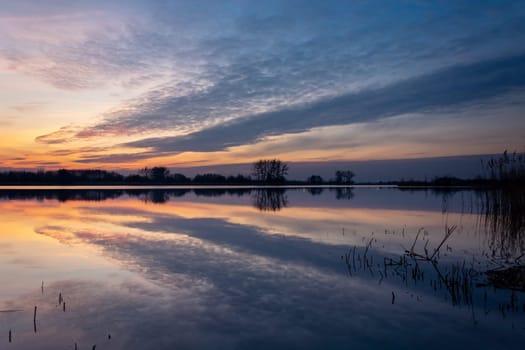 A mirror reflection of the evening clouds in the lake, Stankow, Lubelskie, Poland