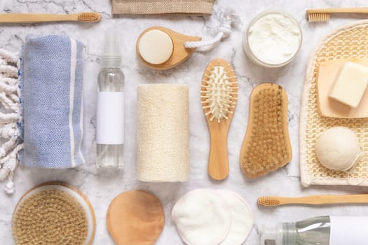 Organic natural cosmetics and zero waste reusable accessories for skin and hair care on marble flat lay. Top view of eco friendly beauty products for bath, massage or spa salon