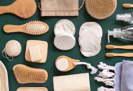 Organic natural cosmetics and zero waste reusable accessories for skin and hair care on dark green flat lay. Top view of eco friendly beauty products for bath, massage or spa salon