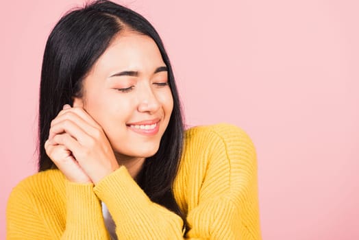 Happy Asian portrait beautiful cute young cheerful mixed race woman smile shy satisfied expression, studio shot isolated pink background, Thai female bashful pleasure put both hand on face, copy space