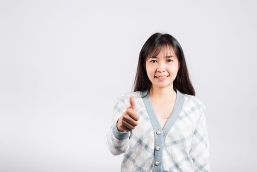 Happy woman smile showing finger thumbs up, Portrait Asian beautiful young female successful like finger gesture, OK sign to agree studio shot isolated on white background with copy space
