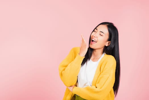 Happy Asian portrait beautiful cute young woman standing winning and surprised excited screaming laugh hand cover mouth, studio shot isolated pink background, Thai female wow scream with copy space