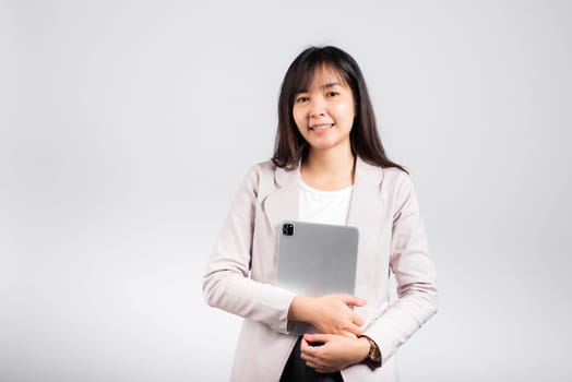 Portrait of Asian beautiful young woman smiling holding tablet computer, Happy lifestyle female teen hugging digital tablet pc, studio shot isolated on white background, university e-book equipment