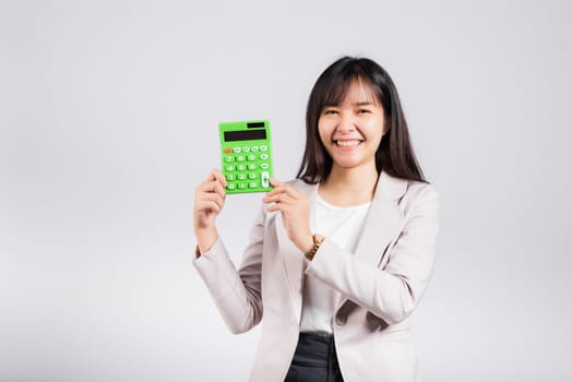 Tax day concept. Woman confident smiling holding electronic calculator, Portrait excited happy Asian young female studio shot isolated on white background, Business Account and finance counting income
