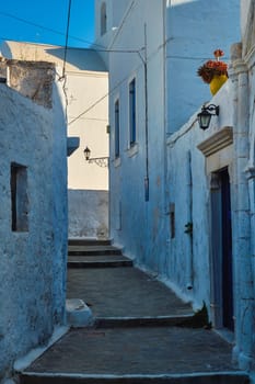 Greek village typical street view with whitewashed houses and stairs. Plaka town, Milos island, Greece